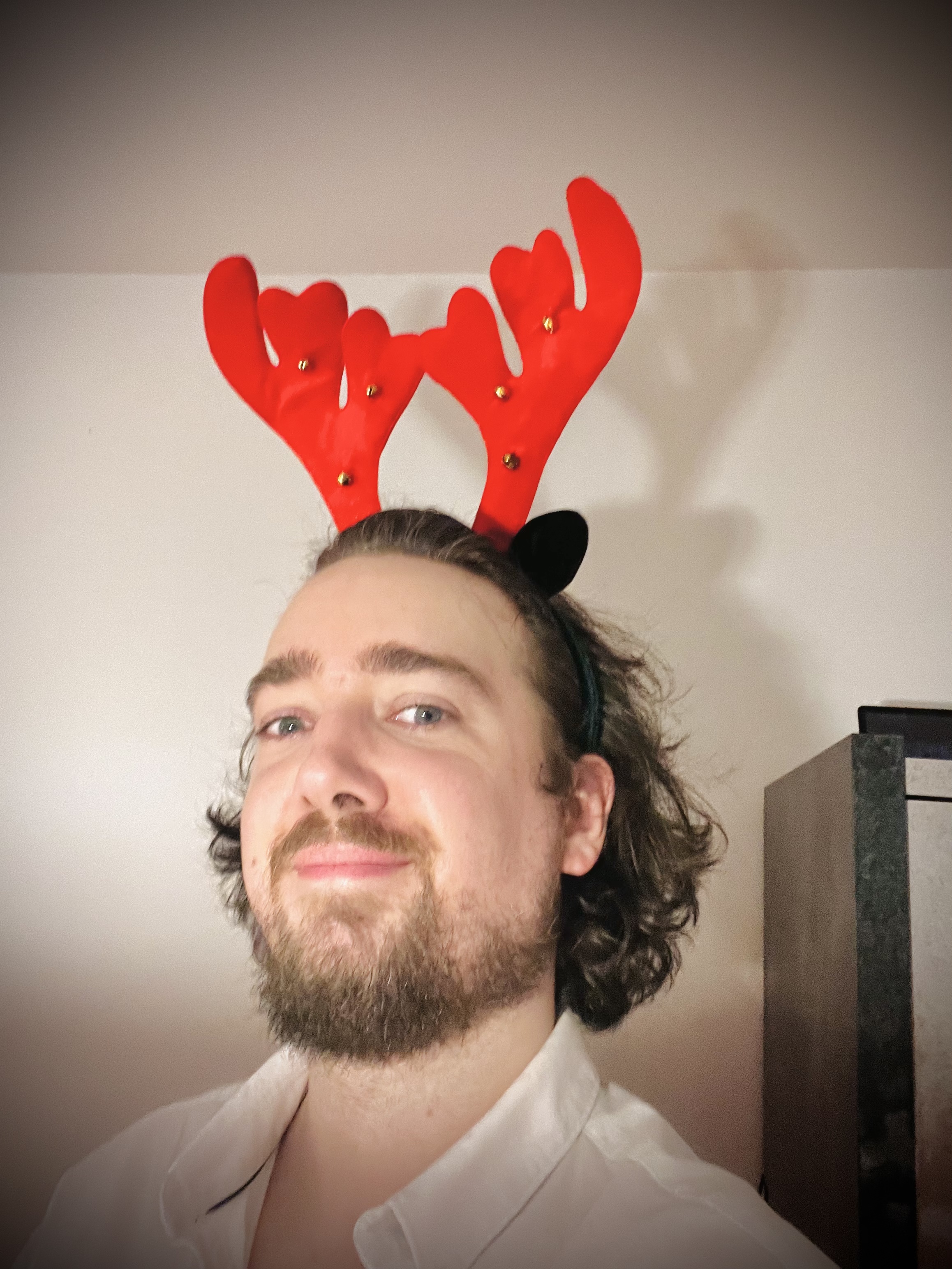 Selfie of me smiling wearing a red christmas reindeer fancy.